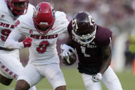 New Mexico cornerback Donte Martin (8) strips the ball away from Texas A&M wide receiver Evan Stewart (1) for a fumble after a catch and run during the first quarter of an NCAA college football game Saturday, Sept. 2, 2023, in College Station, Texas. (AP Photo/Sam Craft)
