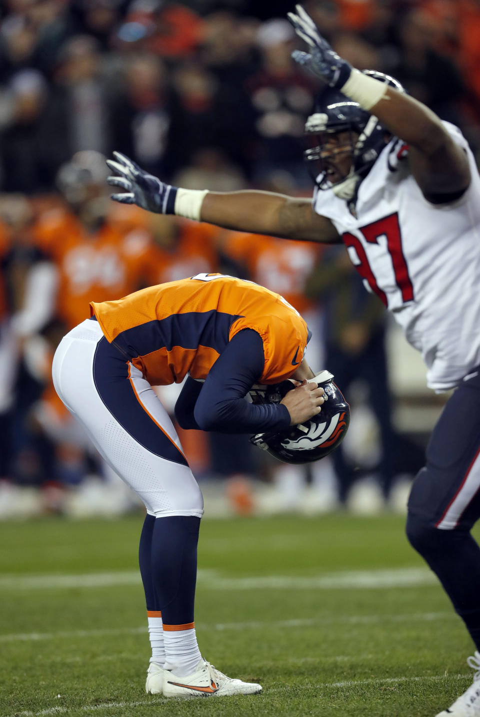 Denver Broncos kicker Brandon McManus hangs his head after missing a game winning field goal attempt as Houston Texans defensive end Angelo Blackson (97) celebrates during the second half of an NFL football game, Sunday, Nov. 4, 2018, in Denver. The Texans won 19-17. (AP Photo/David Zalubowski)