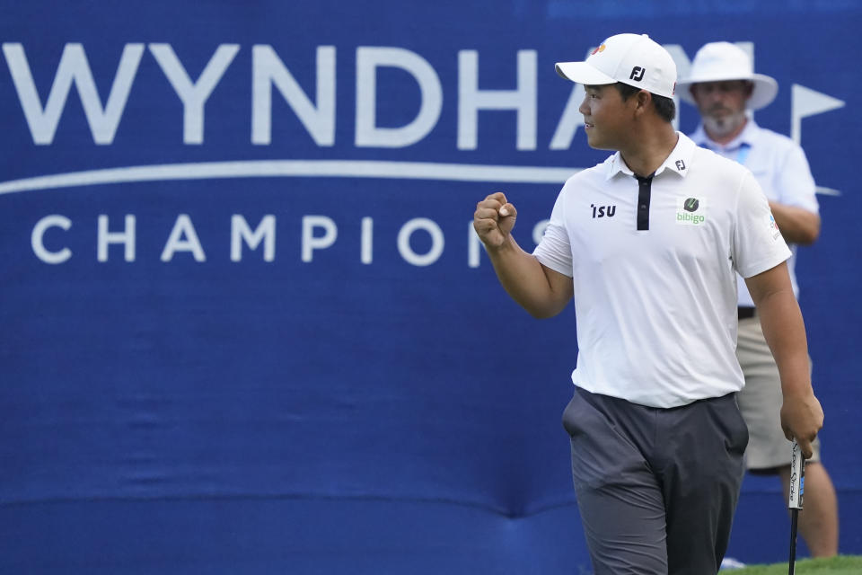 Joohyoung Kim, right, of South Korea, reacts after winning the Wyndham Championship golf tournament in Greensboro, N.C., Sunday, Aug. 7, 2022. (AP Photo/Chuck Burton)