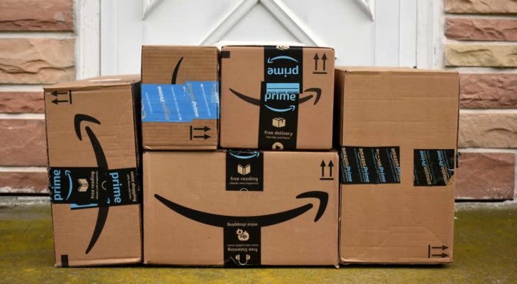 stack of Amazon (AMZN) delivery boxes at a front door