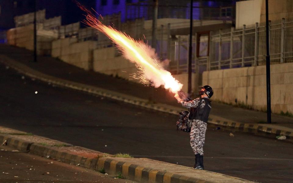 Jordanian security forces disperse a protest in Amman - Khali Mazraawi/AFP