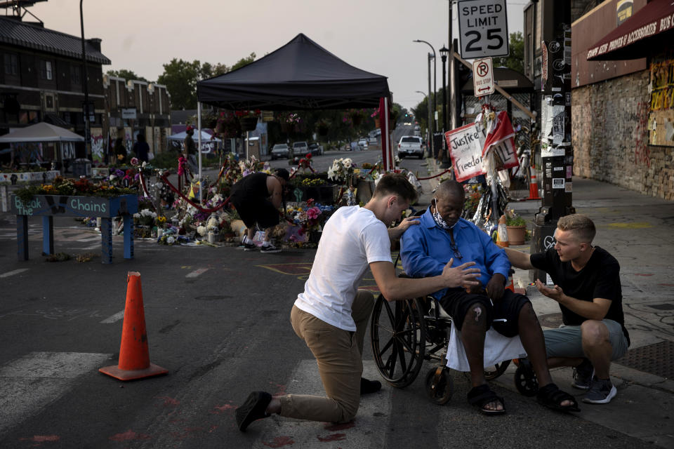 A local Christian group prays at the site of his memorial in Minneapolis on Aug. 25, 2020. (Ed Ou / NBC News)
