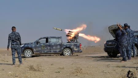 Federal police forces launch a rocket during clashes with Islamic State militants in south of Mosul. REUTERS/Stringer