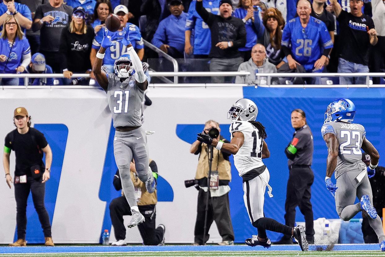 Lions safety Kerby Joseph intercepts a pass intended for Raiders wide receiver Davante Adams during the first half at Ford Field on Monday, Oct. 30, 2023.