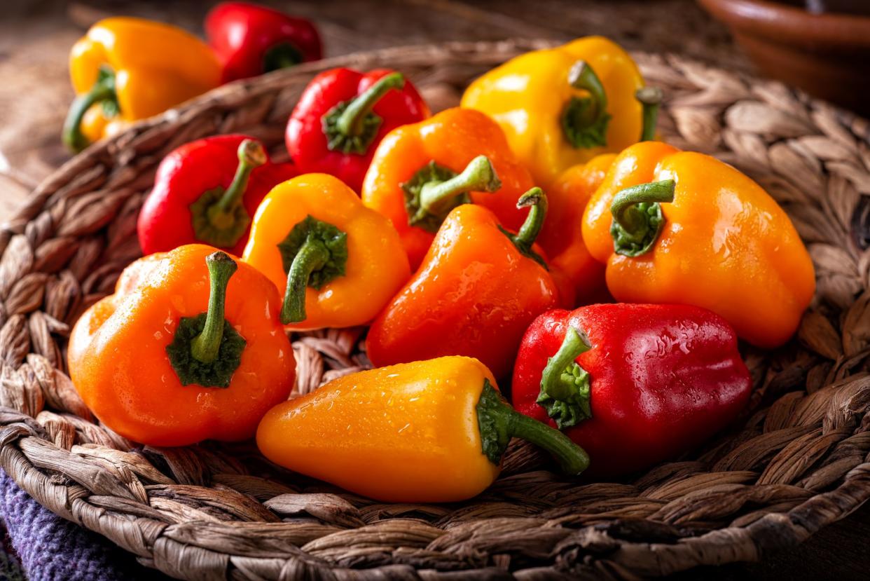 A basket of fresh colorful bell peppers.