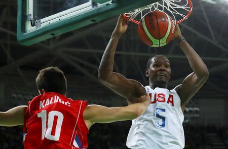 Kevin Durant dunks over Nikola Kalinic of Serbia. REUTERS/Jim Young