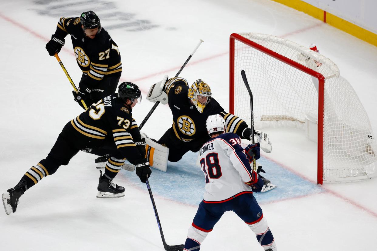 Columbus Blue Jackets center Boone Jenner scores a goal past Boston Bruins goaltender Jeremy Swayman and defenders Charlie McAvoy and Hampus Lindholm during the second period of an NHL hockey game, Sunday, Dec. 3, 2023, in Boston. (AP Photo/Mary Schwalm)