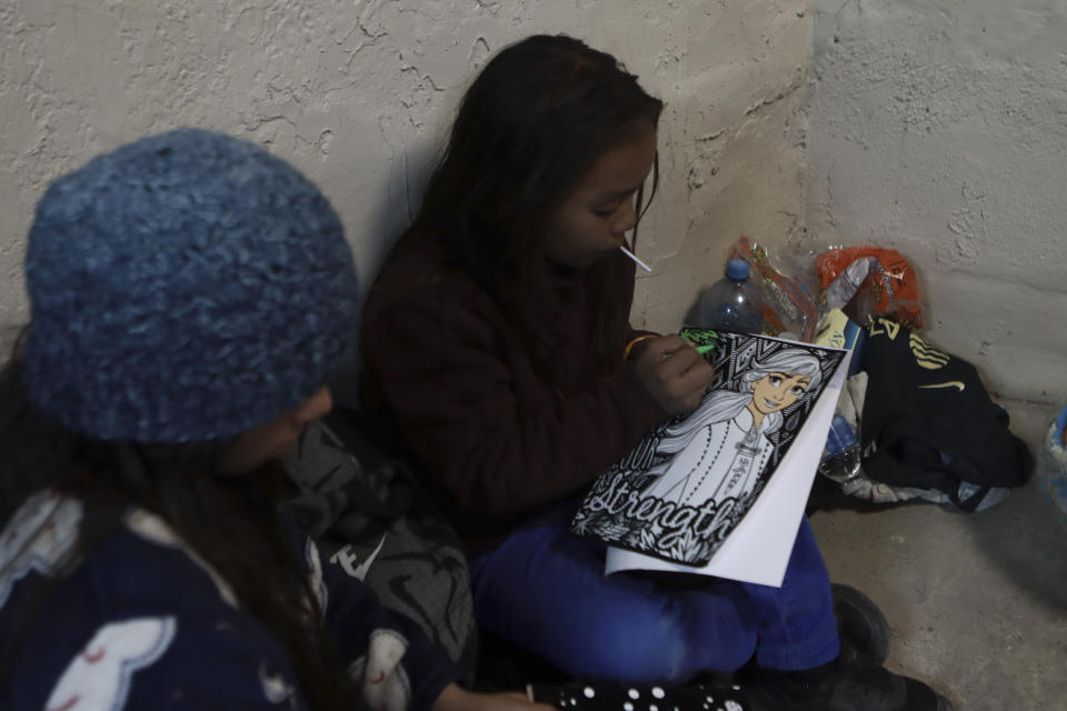 A migrant youth draws while living at a shelter on the U.S.-Mexico border in Ciudad Juarez, Mexico, Monday, Dec. 19, 2022. Pandemic-era immigration restrictions in the U.S. known as Title 42 are set to expire on Dec. 21. (AP Photo/Christian Chavez)