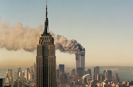 The twin towers of the World Trade Centre burn behind the Empire State Building on September 11, 2001. Picture: AP