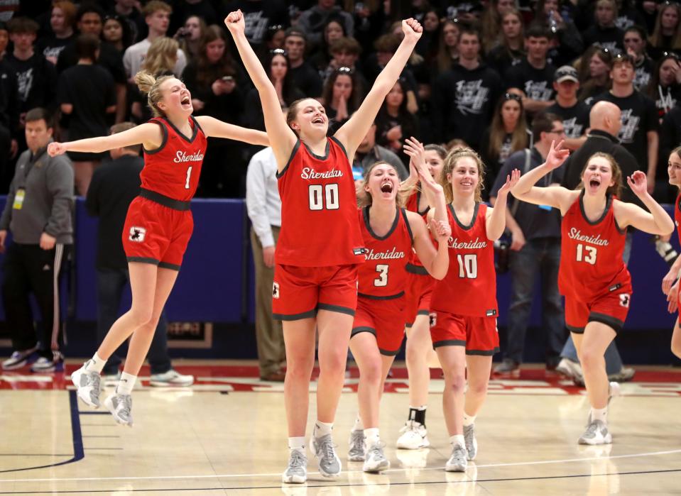 Sheridan senior Faith Stinson (00) raises her arms in victory as she celebrates a 68-60 triple-overtime win against Norton with teammates Jamisyn Stinson (1), Bailey Beckstedt (3), Kinze Miller (10) and Kaelyn Moss (13) after an OHSAA Division II state semifinal March 10 at UD Arena in Dayton. Sheridan held Norton scoreless in the third overtime to advance to Saturday's championship game against Kettering Alter. Read the full story at www.zanesvilletimesrecorder.com.