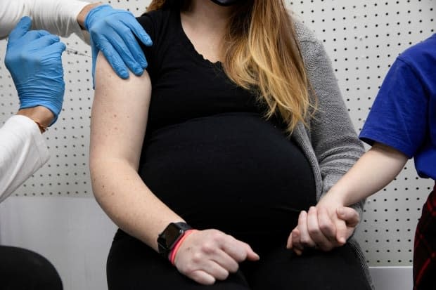 A pregnant woman receives a vaccine for COVID-19 at a pharmacy in Schwenksville, Pennsylvania.  (Hannah Beier/File Photo/Reuters - image credit)