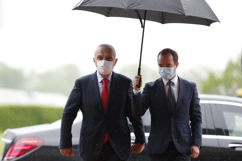 Albania's President Ilir Meta, left, arrives at the Brdo-Brijuni summit, in Brdo, Slovenia, Monday, May 17, 2021. The Brdo-Brijuni Process summit had originally been planned for last year, to coincide with the 10th anniversary of the initiative, but had been postponed twice due to the coronavirus pandemic. (AP Photo/Darko Bandic)