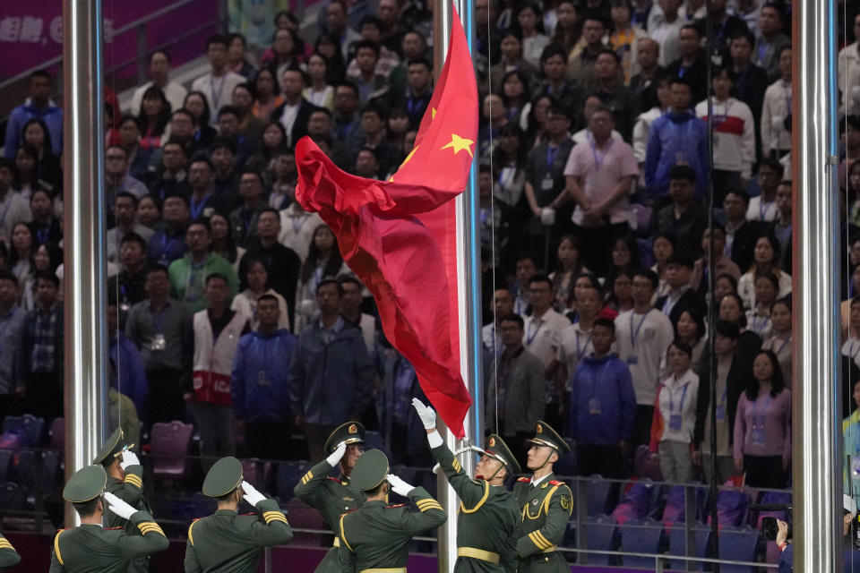 Honor guard hoist Chinese national flag during the closing ceremony of the 19th Asian Games in Hangzhou, China, Sunday, Oct. 8, 2023. (AP Photo/Aaron Favila)