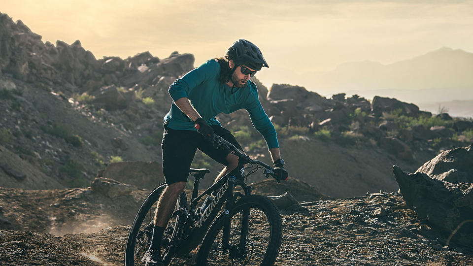 Man on mountain bike wearing Garmin Fenix 7 smartwatch