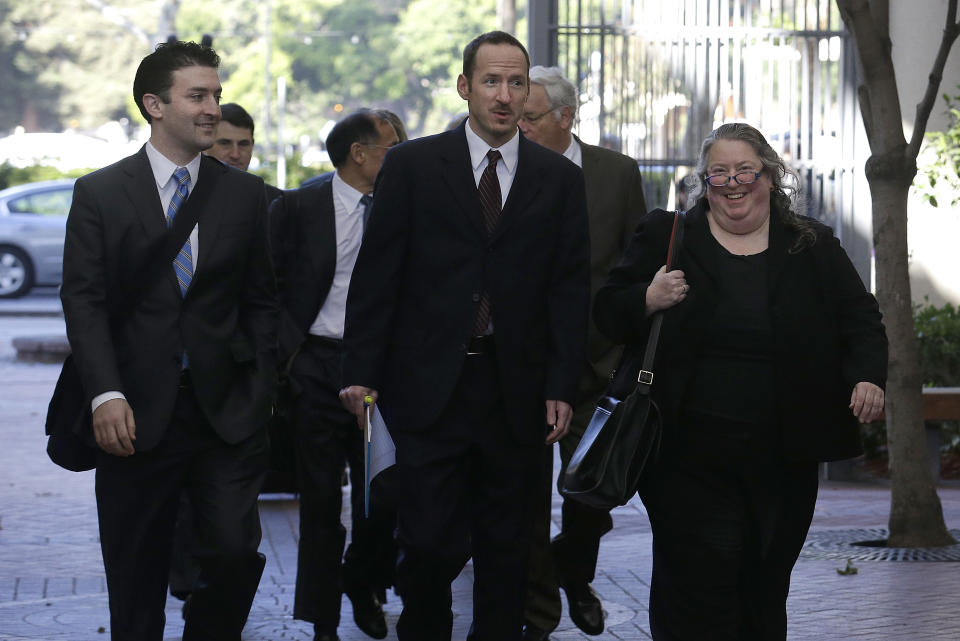 Apple attorney Rachel Krevans, right, walks with others to a federal courthouse in San Jose, Calif., Tuesday, April 29, 2014. The Silicon Valley court battle between Apple and Samsung is entering its final phase. Lawyers for both companies are expected to deliver closing arguments Tuesday before jurors are sent behind closed doors to determine a verdict in a closely watched trial over the ownership of smartphone technology. (AP Photo/Jeff Chiu)