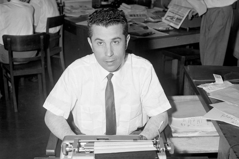 FILE - AP correspondent Seymour Topping is shown at his typewriter in Berlin, in this July 21, 1958, file photo. Topping, among the most accomplished foreign correspondents of his generation for The Associated Press and the New York Times and later a top editor at the Times and administrator of the Pulitzer Prizes, died on Sunday, Nov. 8, 2020, in White Plains, N.Y. He was 99. Topping passed away “peacefully” at White Plains Hospital, his daughter Rebecca said in an emailed statement. (AP Photo/File)