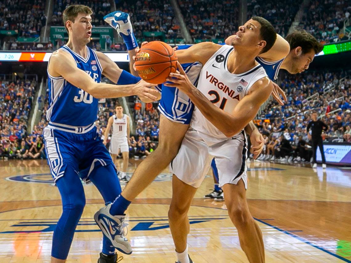 Duke’s Ryan Young (15) collides with Virginia’s Kadin Shedrick (21)during the second half of the championship game of the ACC Tournament on Saturday, March 11, 2023 at the Greensboro Coliseum in Greensboro, N.C.