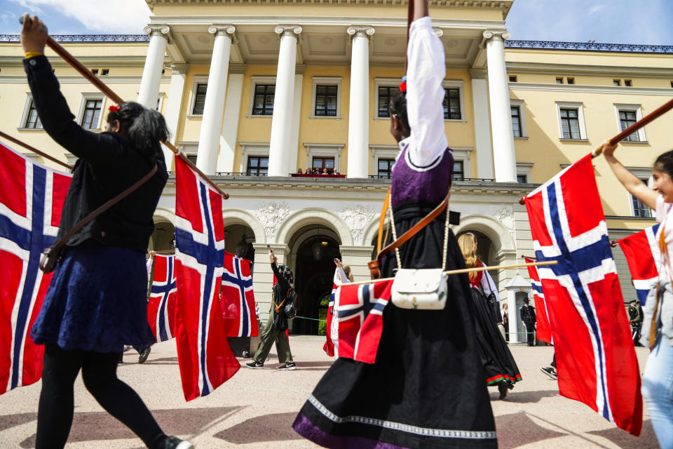 The Norwegian Crown Prince Haakon, Prince Sverre Magnus, Princess Ingrid Alexandra, Crown Prince Mette Marit Queen Sonja, and King Harald wave from the balcony at the Royal Palace in Oslo, as school children parade to mark the Norwegian Constitutional Day on May 17, 2019. (Photo by Berit ROALD / NTB scanpix / AFP) / Norway OUT        (Photo credit should read BERIT ROALD/AFP/Getty Images)