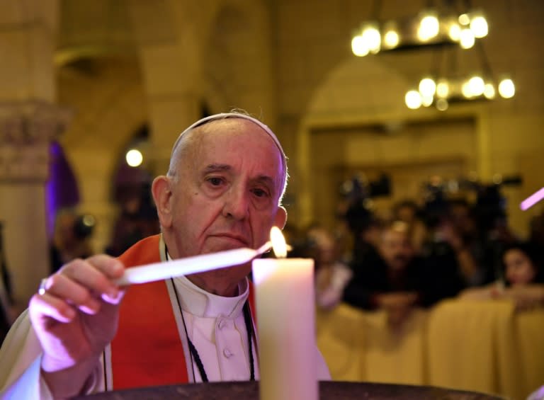 Pope Francis lights a candle at Cairo's Saint Peter and Saint Paul church, the target of a December suicide bomb attack that killed 29 people, on April 28, 2017