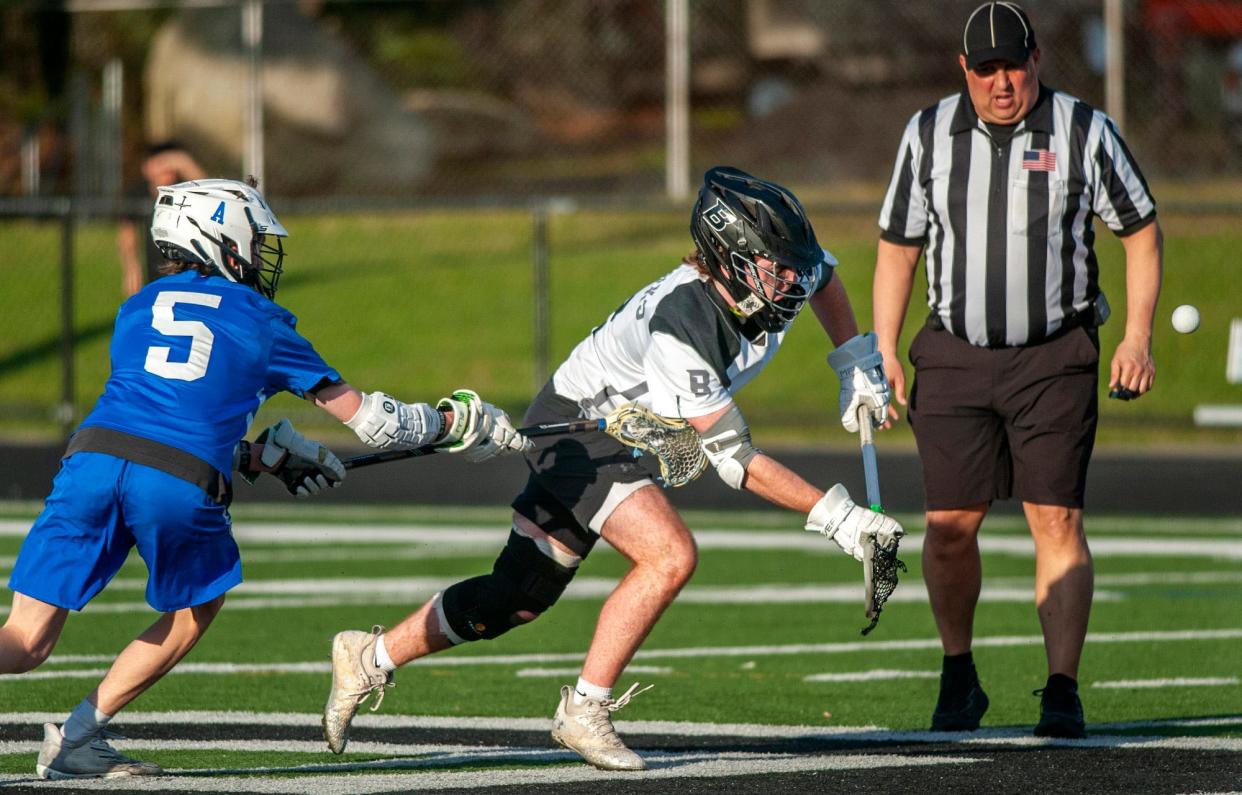 Bellingham High School lacrosse player Jack Baker is a FOGO (face off get off) specialist, here against Ashland's Alex Dinsdale, May 2, 2024.