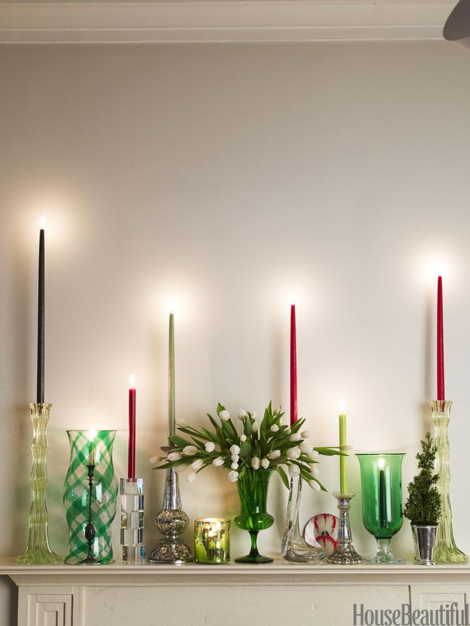 <p>Instead of a garland, dress up a mantel with a <a href="https://www.housebeautiful.com/room-decorating/colors/tips/g492/red-and-green-christmas-decorations/" rel="nofollow noopener" target="_blank" data-ylk="slk:mix of candlesticks;elm:context_link;itc:0;sec:content-canvas" class="link ">mix of candlesticks</a> — tall, small, mercury glass, crystal. Instead of ivory candles, opt for red, cranberry, and shades of green. </p>