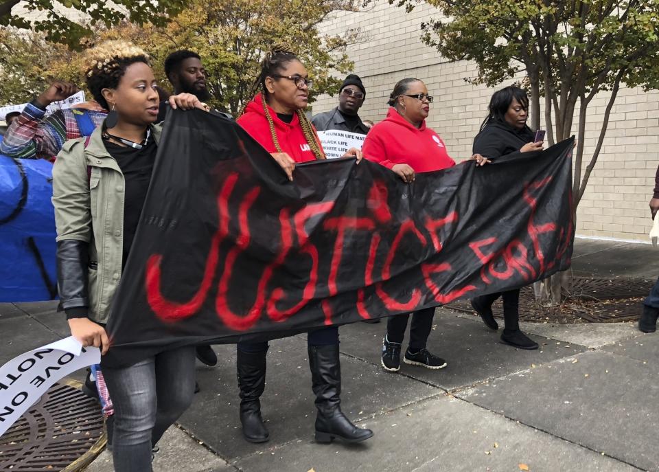 FILE - In this Nov. 24, 2018, file photo, protesters carry a sign reading "Justice for E.J." during a protest at the Riverchase Galleria in Hoover, Ala. The family of Emantic "EJ" Bradford Jr., who was killed by police who apparently mistook him for the gunman in an Alabama mall shooting, asked the state attorney general Monday, Jan. 28, 2019, to meet with them and release video of the shooting. (AP Photo/Kim Chandler, File)