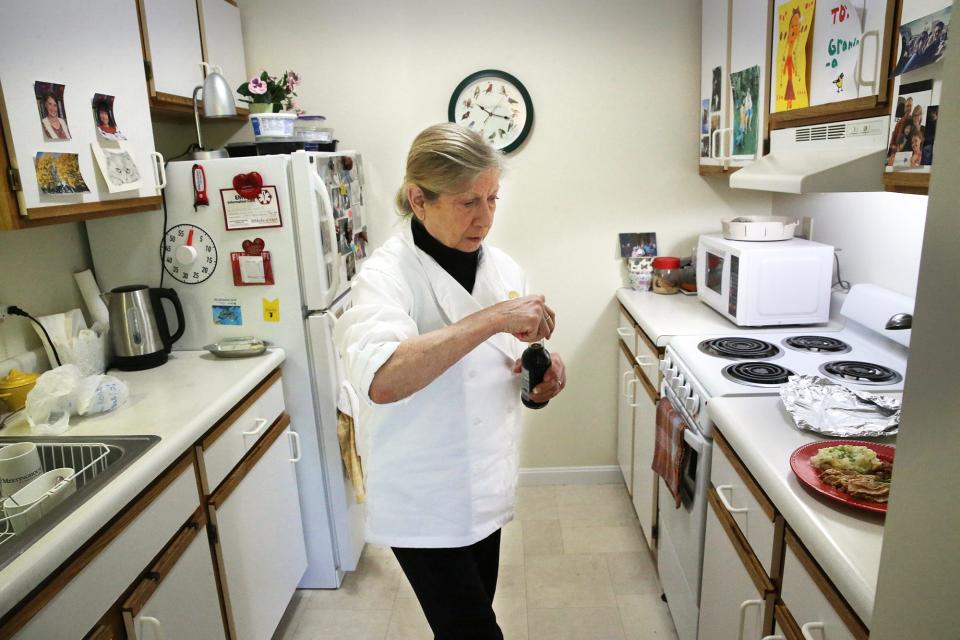 Jean Kerr of Chefs for Seniors puts the finishing touches on a meal prepared in her client Dorothy Richmond's Kittery, Maine, home.