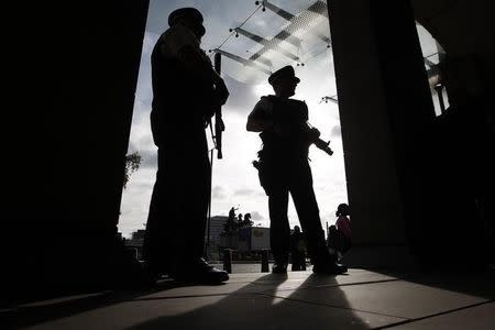 Armed police officers stand on duty outside Portcullis House in central London October 11, 2011. REUTERS/Andrew Winning