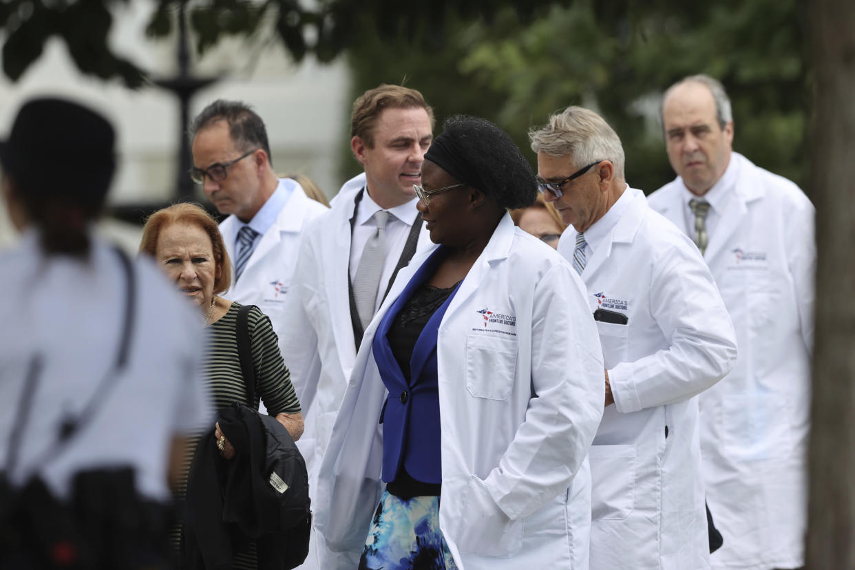 Dr. Stella Immanuel, center, and other members of the American Frontline Doctors seen while at Capitol Hill after giving a press conference addressing COVID-19 misinformation in Washington D.C. on July 27, 2020. (mpi34/MediaPunch /IPX via AP)