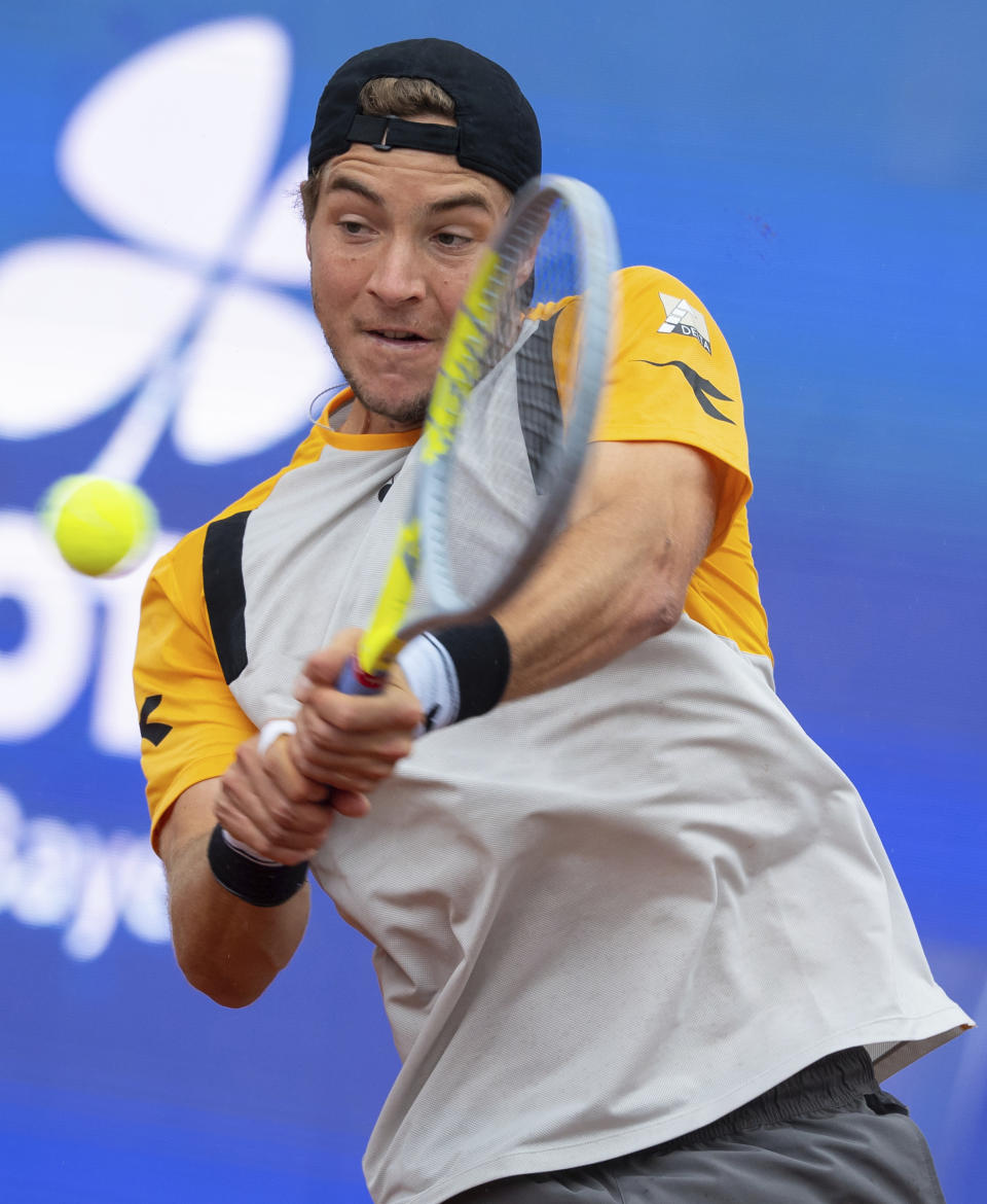 Jan-Lennard Struff of Germany returns the ball to Nikoloz Basilashvili of Georgia during his tennis ATP final match in Munich, Germany, Sunday, May 2, 2021. (Sven Hoppe/dpa via AP)