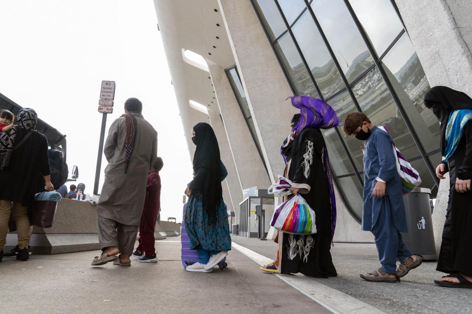 People evacuated from Kabul, Afghanistan, wait to board a bus after they arrived at Washington Dulles International Airport, in Chantilly, Va., on Monday, Aug. 30, 2021. (AP Photo/Jose Luis Magana)