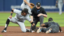 Tampa Bay Rays' Randy Arozarena (56) steals second base ahead of the tag by Chicago White Sox second baseman Nicky Lopez (8) during the fourth inning of a baseball game Monday, May 6, 2024, in St. Petersburg, Fla. Making the call is umpire Carlos Torres. (AP Photo/Chris O'Meara)