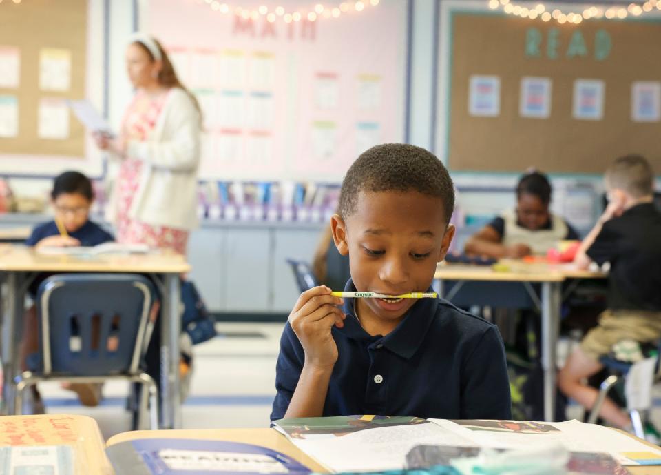 Third grader Liam Armond, 9, reads along during Palm Pointe K-8 teacher Katlyn McCue's reading lesson, Tuesday, Feb. 6, 2024, in Port St. Lucie. McCue is a recipient of St. Lucie Public School's Promise is a Promise program. The program guarantees participating St. Lucie County students a teaching job in the district after graduation. She is a recipient of the county's Outstanding First Year Teacher award.