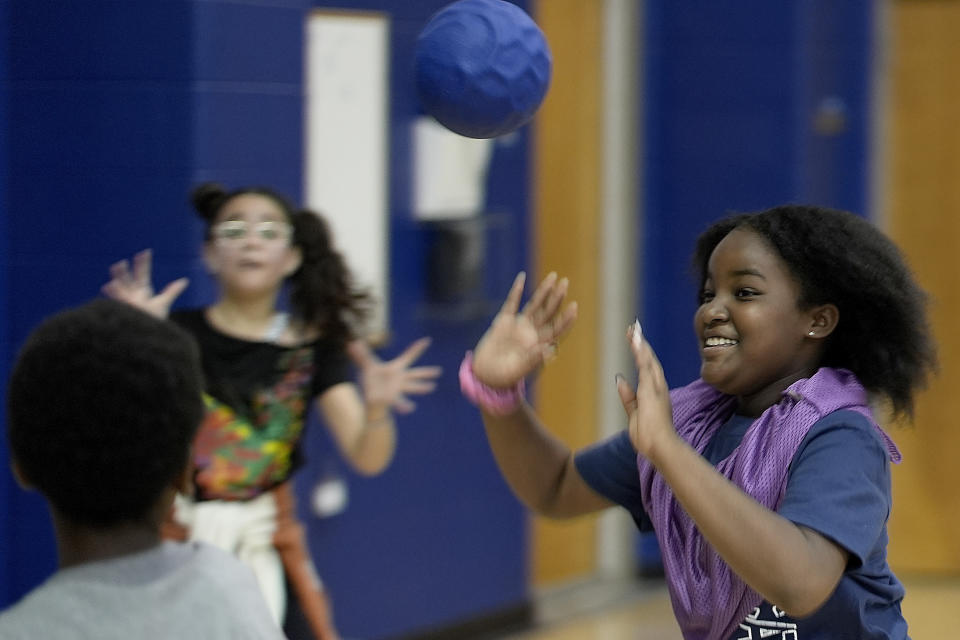 Fifth grader Malaya Webster, right, plays a game with other students at Williams Science and Arts Magnet school Friday, May 10, 2024, in Topeka, Kan. The school is just a block from the former Monroe school which was at the center of the Brown v. Board of Education Supreme Court ruling ending segregation in public schools 70 years ago. (AP Photo/Charlie Riedel)