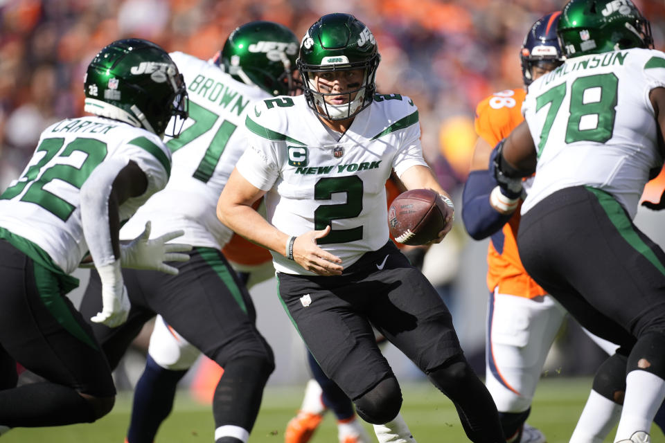 New York Jets quarterback Zach Wilson (2) prepares to hand the ball off during the first half of an NFL football game against the Denver Broncos, Sunday, Oct. 23, 2022, in Denver. (AP Photo/David Zalubowski)