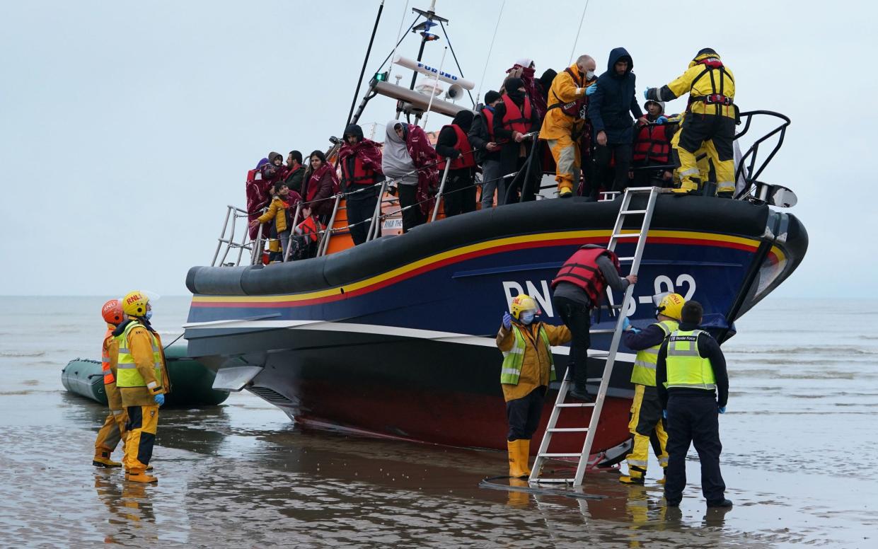 A group of migrants brought to shore by the RNLI at Dungeness, Kent on Saturday - Gareth Fuller