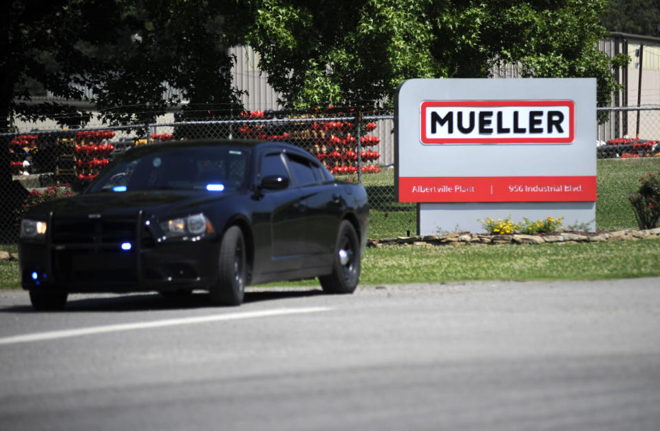 A police car guards the entrance to a Mueller Co. fire hydrant plant where police said multiple people were shot to death and others were wounded in Albertville, Ala., on Tuesday, June 15, 2021. (AP Photo/Jay Reeves)