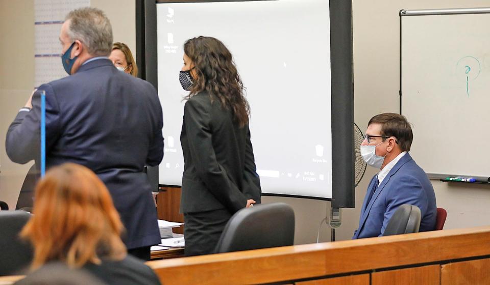 Former Cohasset teacher Jeffrey Knight, right, listens as his lawyers speak to Judge Mark Coven in Quincy District Court on Monday, Nov. 15, 2021.