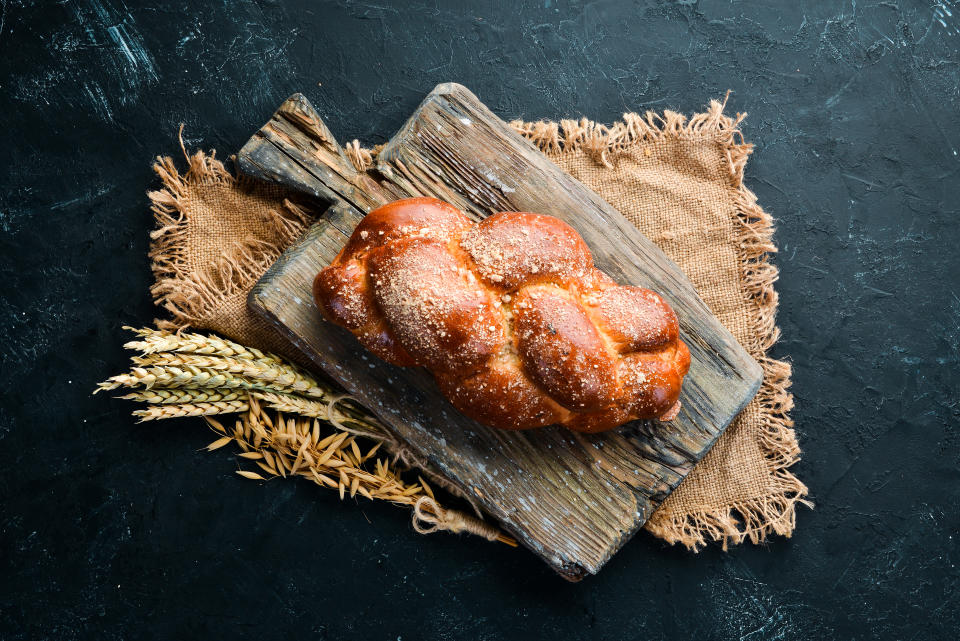 Braided bread with flour. Top view. Free space for your text.