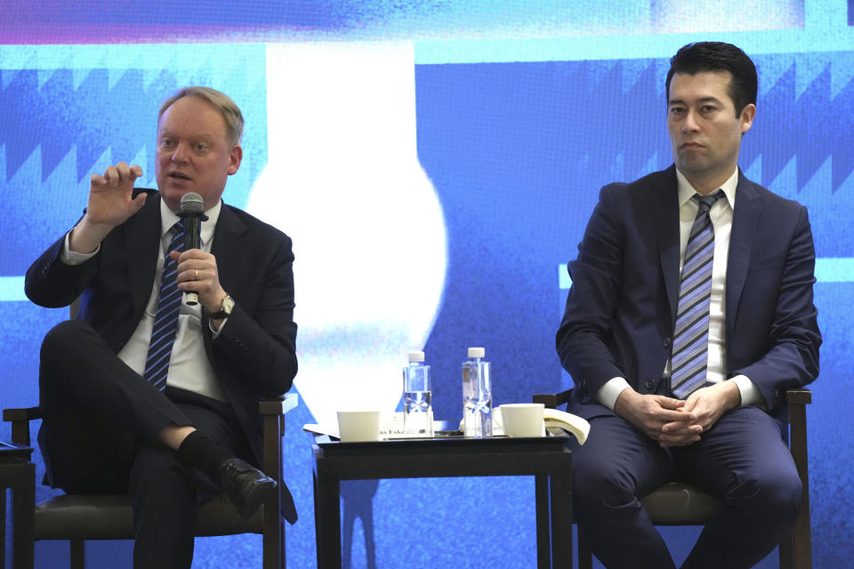 President of the European Union Chamber of Commerce in China Jens Eskelund, left, speaks and China Macro Group Managing Director Markus Herrmann Chen listens during a press conference for European Chamber in Beijing, China, Wednesday, March 20, 2024. Uncertainty and “draconian regulations” have drastically raised risks for foreign businesses in China, a report by a European business group said Wednesday. (AP Photo/Tatan Syuflana)