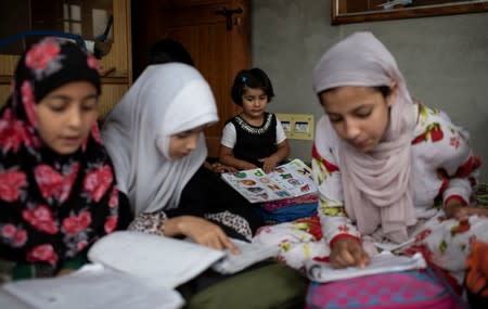 The Wider Image: Barricades and books in restive Kashmir neighbourhood