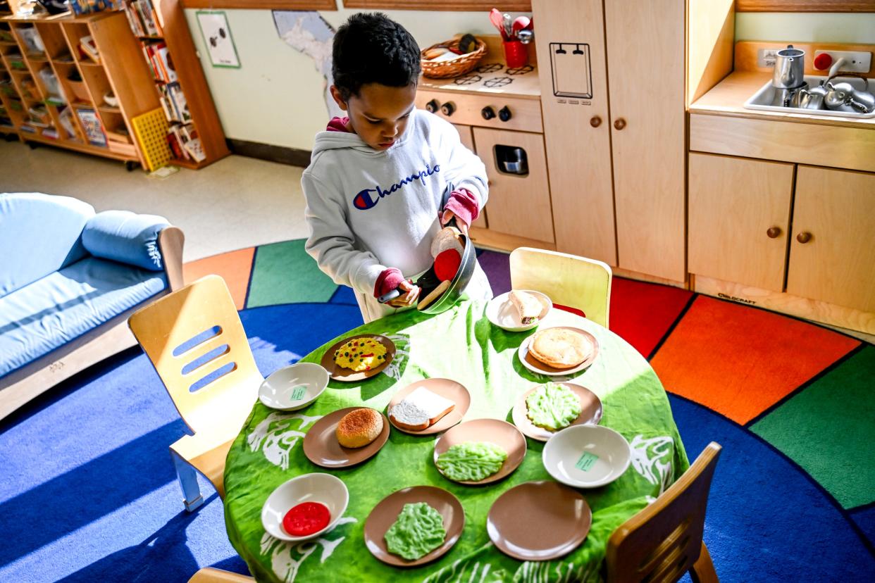 Preschooler Semaj Johnson serves a pretend meal in the classroom at Cumberland Elementary School on Thursday, April 18, 2024, in Lansing.