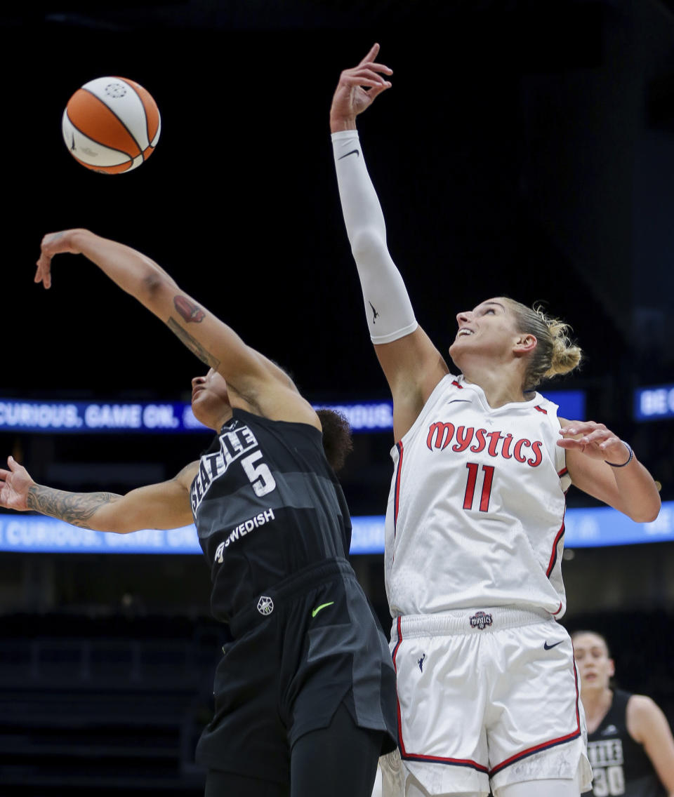 Seattle Storm forward Gabby Williams (5) tips the ball away from Washington Mystics forward Elena Delle Donne (11) during the first half of Game 1 of a WNBA basketball first-round playoff series Thursday, Aug. 18, 2022, in Seattle. (AP Photo/Lindsey Wasson)