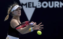Canada's Eugenie Bouchard makes a forehand return to Italy's Martina Trevisan during their women's singles qualifying match for the Australian Open tennis championship in Melbourne, Australia, Friday, Jan. 17, 2020. (AP Photo/Lee Jin-man)