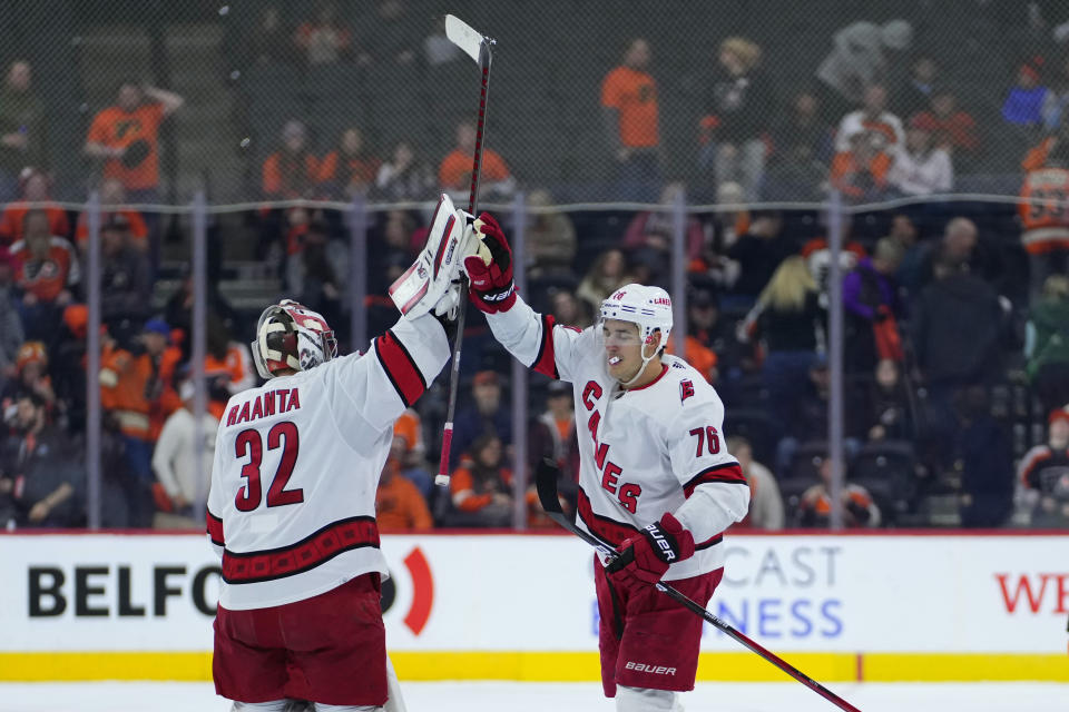 Carolina Hurricanes' Antti Raanta, left, and Brady Skjei celebrate after an NHL hockey game against the Philadelphia Flyers, Saturday, Oct. 29, 2022, in Philadelphia. (AP Photo/Matt Slocum)