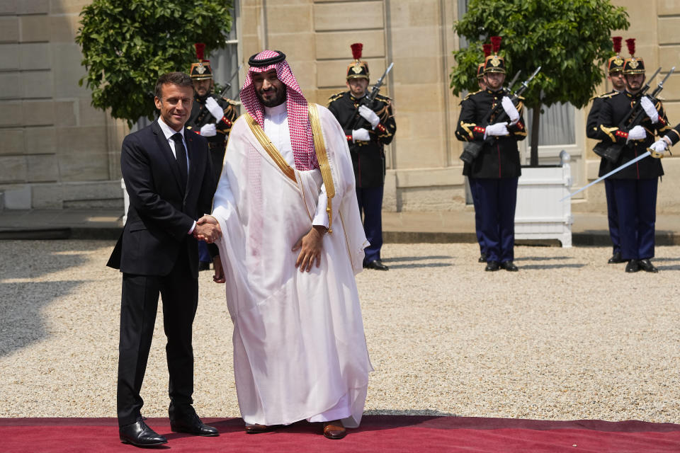 Saudi Crown Prince Mohammed bin Salman is welcomed by French President Emmanuel Macron, Friday, June 16, 2023 at the Elysee Palace in Paris. Saudi Crown Prince Mohammed bin Salman meets Emmanuel Macron as part of an official visit, during which he will also participate in a global financing summit aimed at fighting poverty and climate change. (AP Photo/Michel Euler)