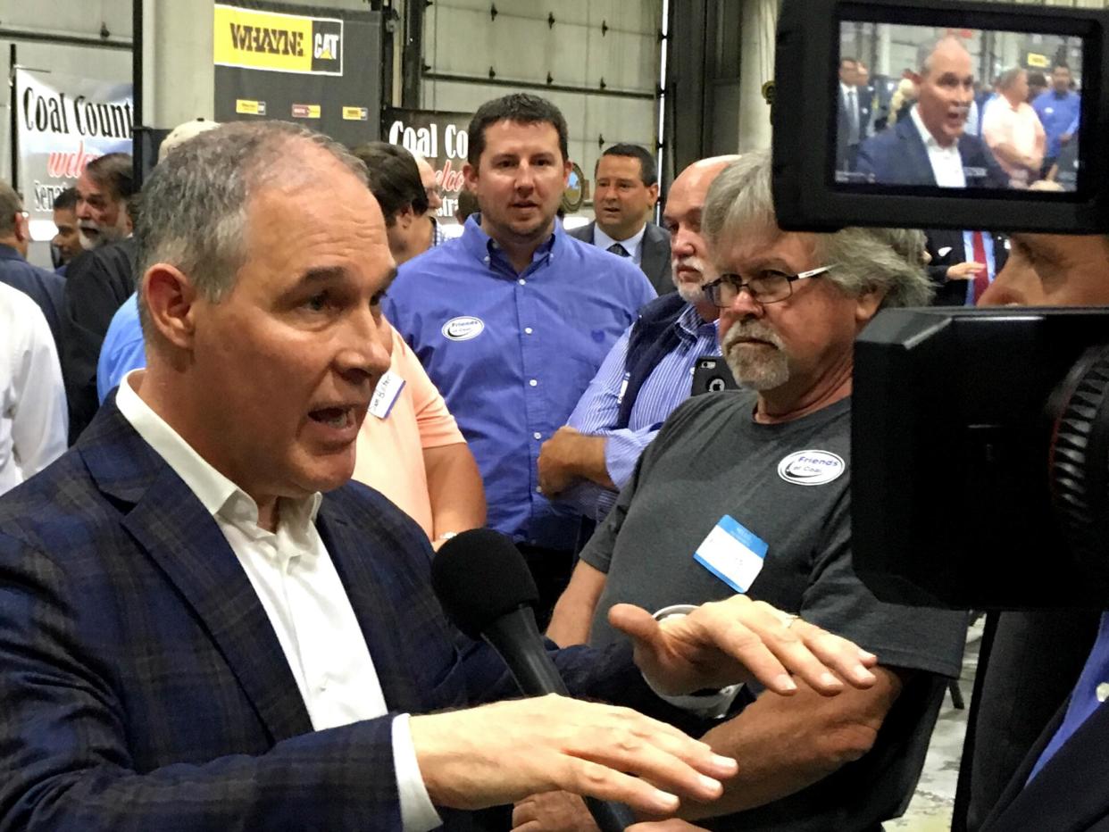 Scott Pruitt talking to reporters. He is said to have been targeted by fellow passengers angry at his attempts to reverse Obama-era climate policies: AP Photo/Adam Beam