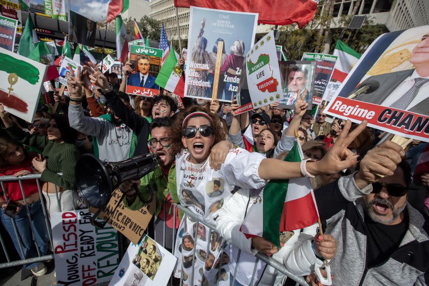 Sepehr Khosravi, left, and Nasrin Nav attend an anti-Iran rally outside Los Angeles City Hall on Saturday.