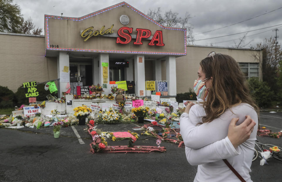 Hollis Wright collects her thoughts as she becomes emotional in front of the Gold Spa, where multiple people were killed in last week's shooting, in Atlanta., Wednesday March 24, 2021. (John Spink/Atlanta Journal-Constitution via AP)