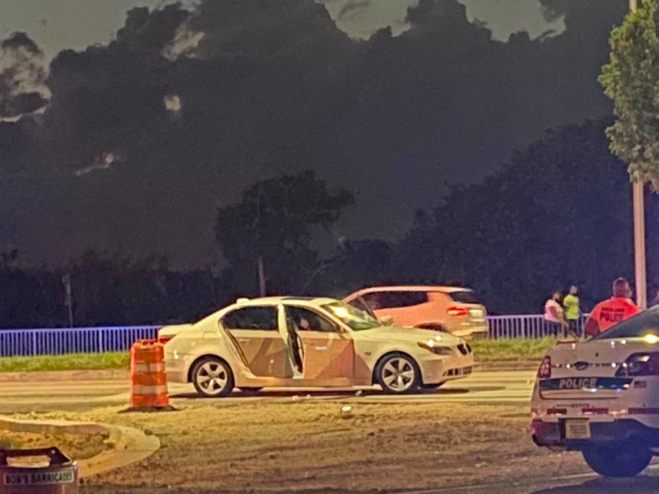 A white BMW is parked on the side of U.S. 1 at the intersection of Southwest 137th Avenue in Princeton Tuesday night, Feb. 23, 2021. The occupants of the car were involved in a shootout with people in another car, according to Miami-Dade County police.